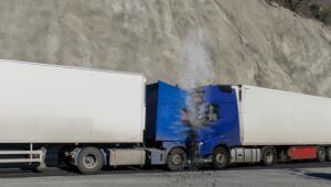 There has been a collision involving two trucks, resulting in a frontal impact. 